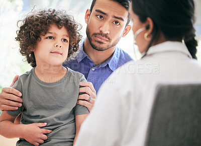 Buy stock photo Shot of a little boy being examined by an unrecognizable doctor while his father holds him