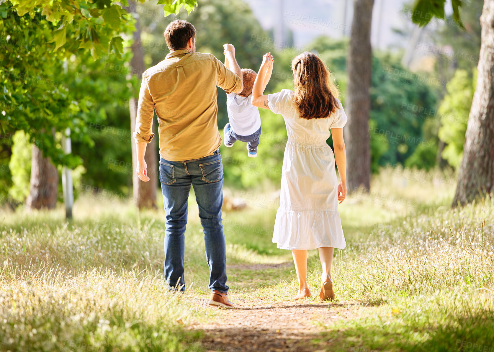 Buy stock photo Back, family and swinging child outdoor park together for bonding, love and support on summer vacation. Woman, man and kid play with care, trust and walking holding hands for freedom on holiday 