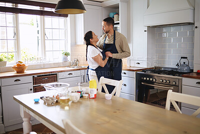 Buy stock photo Shot of an affectionate couple dancing while baking together  at home