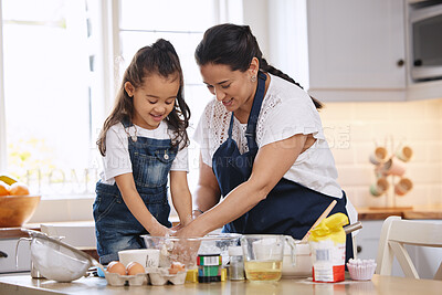 Buy stock photo Shot of a mother and her young daughter baking together at home