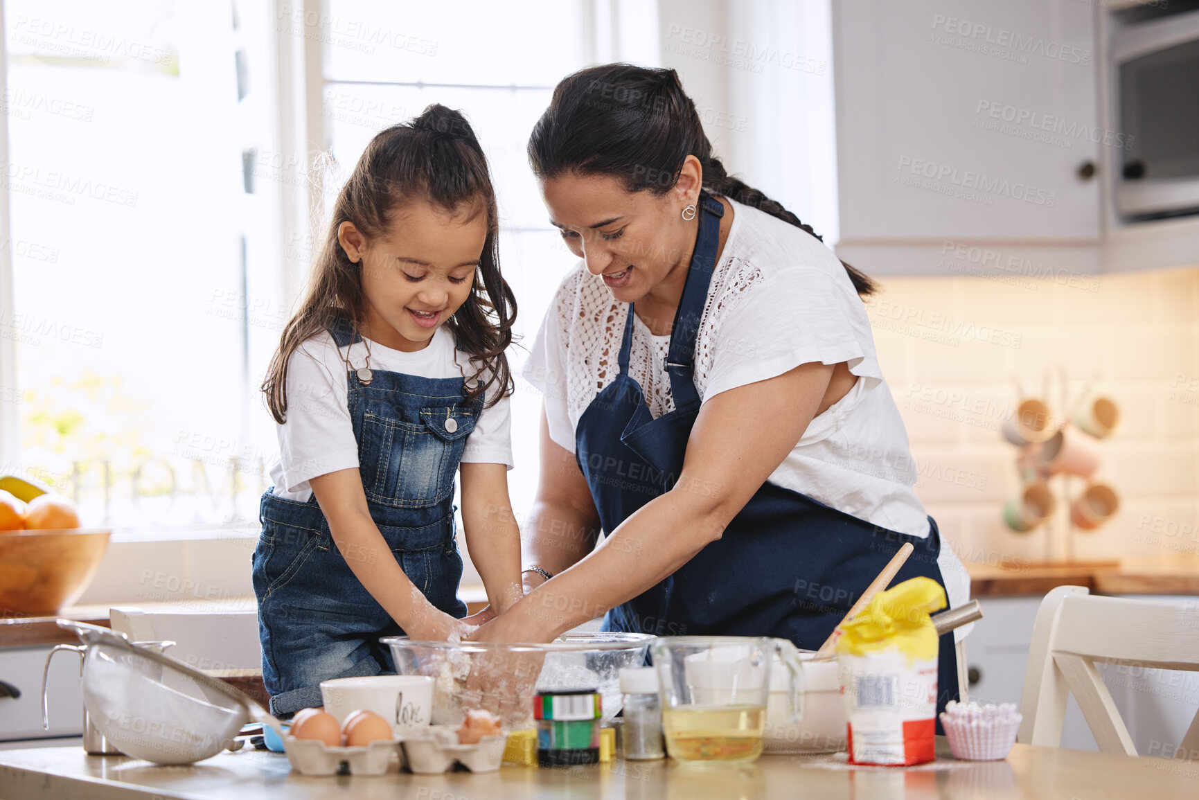 Buy stock photo Mother, child and baking in kitchen with food for helping and teaching cake recipe in home. Mom, young girl and cooking bread or cookies together for learning and relationship bonding with support