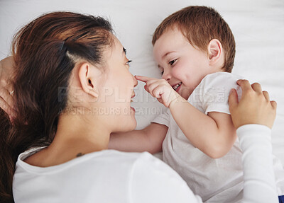 Buy stock photo Love, mother and baby in bed from above, happy and playing, bonding and talking in their home. Family, relax and top view of mom with toddler in a bedroom, wake up and smile while enjoying resting