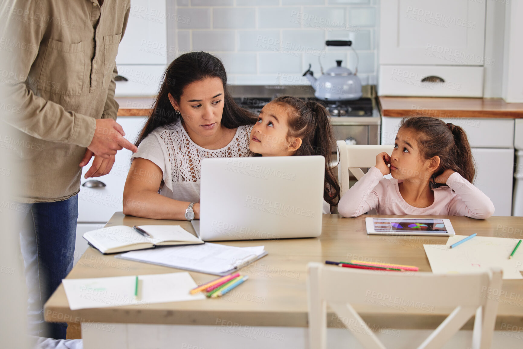 Buy stock photo Shot of two parents helping their children with homework