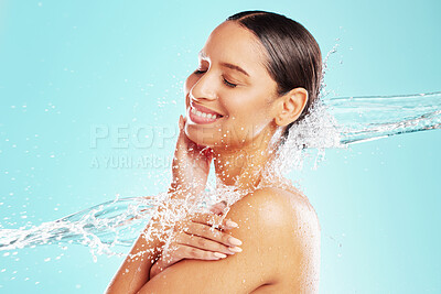 Buy stock photo Shot of an attractive young woman showering against a blue background