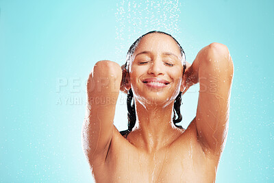 Buy stock photo Shot of an attractive young woman showering against a blue background