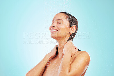 Buy stock photo Shot of an attractive young woman showering against a blue background