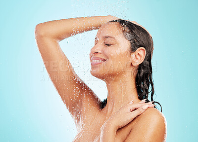 Buy stock photo Shot of an attractive young woman showering against a blue background