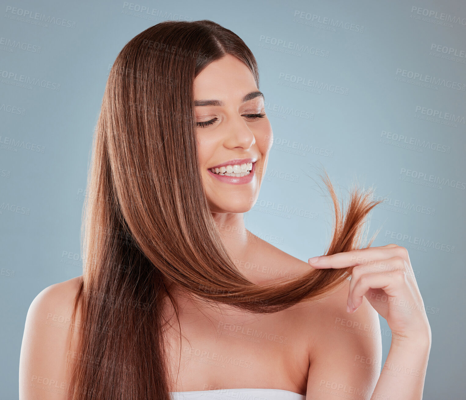 Buy stock photo Hair care, smile and woman with texture in studio for salon treatment, satisfaction and growth of tips. Happy, healthy and female person with pride for split ends, repair or remedy on gray background