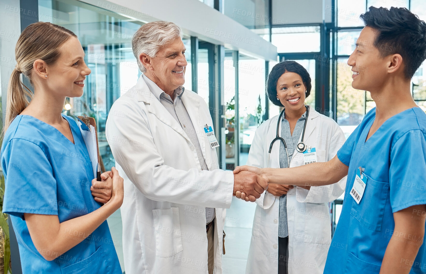 Buy stock photo Healthcare, doctor and nurse shaking hands in a hospital to welcome or celebrate success. Men and women medical group together for a handshake, teamwork and collaboration with trust and support