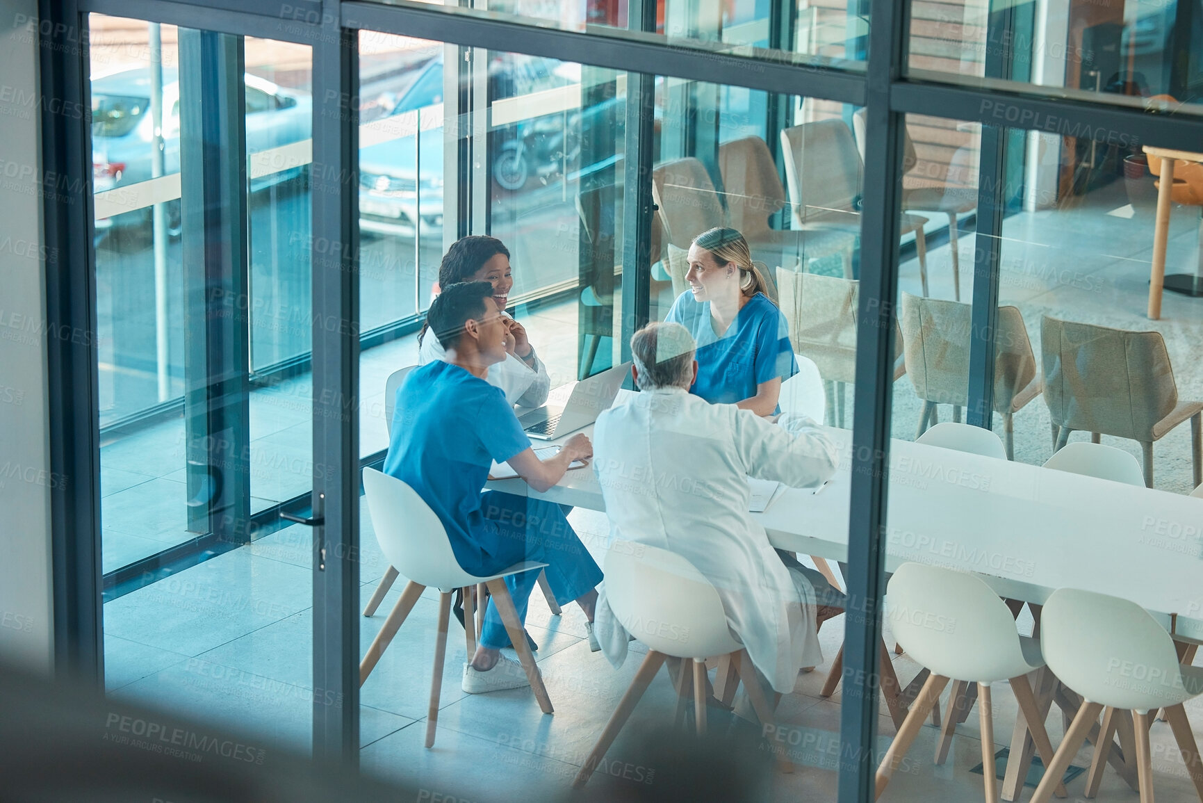 Buy stock photo Healthcare, doctors and team meeting with a laptop for a discussion, planning or research at table. Men and women medical group talking about communication strategy, virus or surgery in a hospital