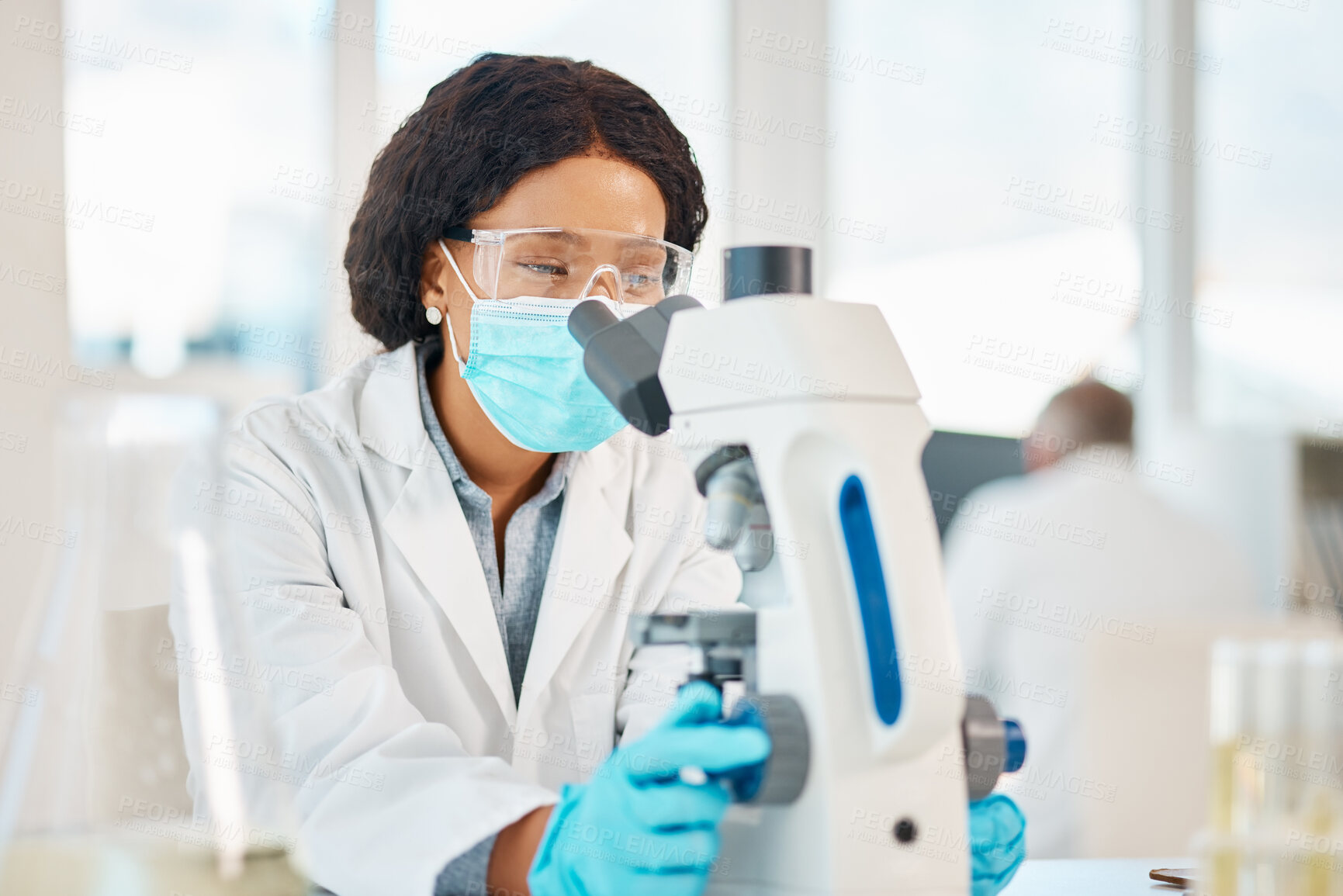 Buy stock photo Microscope, woman and scientist in laboratory for research, discovery or pharmaceutical innovation. Biotechnology, face mask and female biologist with safety goggles for project with medical organism