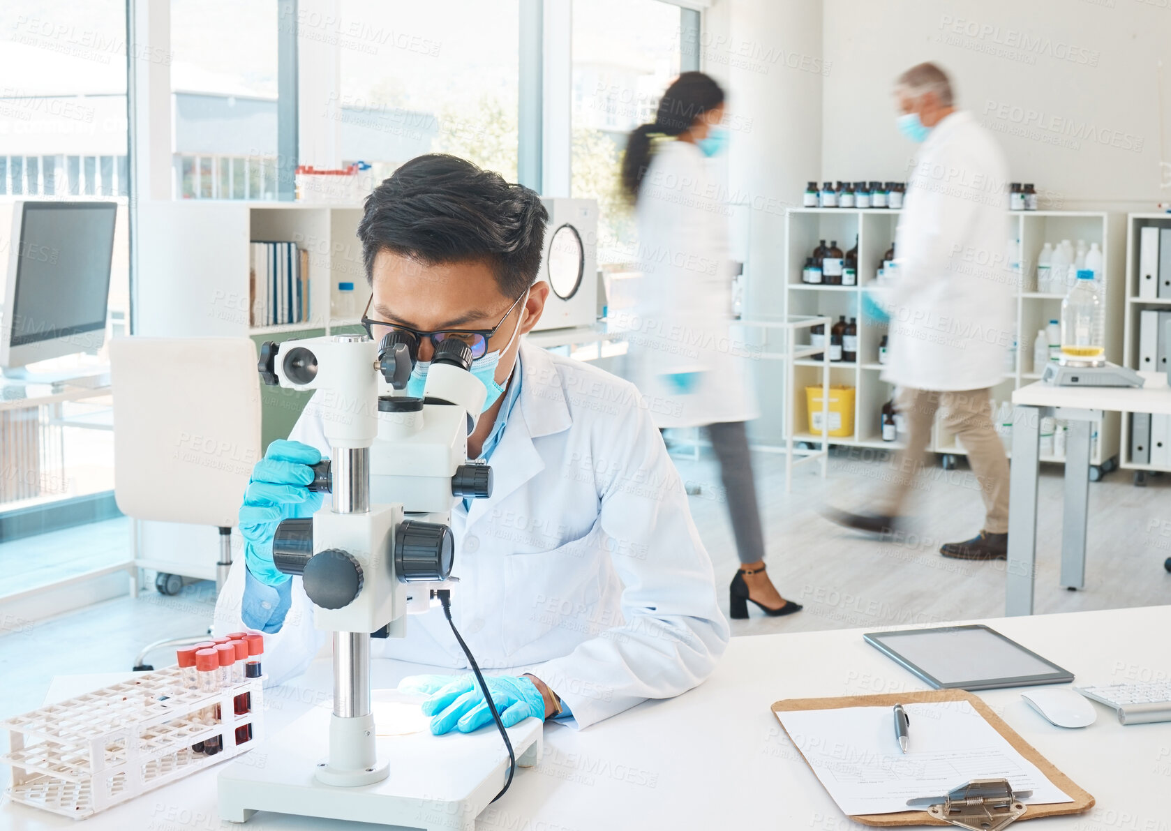 Buy stock photo Microscope, vials and man scientist in laboratory with blur motion for dna, blood test or rna analysis. Biotechnology, research and hematologist with glass tubes for medical innovation discovery.