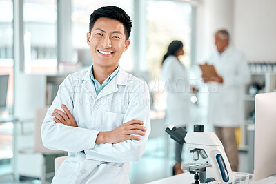 Buy stock photo Portrait of a young scientist standing with his arms crossed in a lab