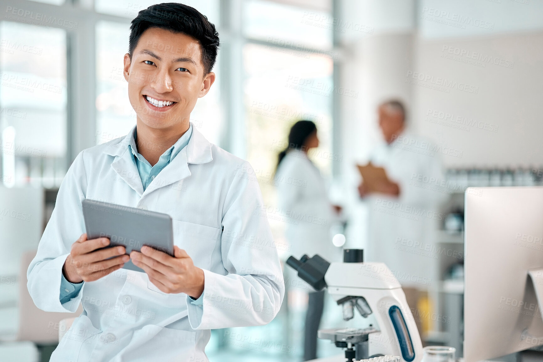 Buy stock photo Tablet, asian man and portrait of a scientist in laboratory, hospital or science research for medicine, chemistry or innovation. Doctor, technology and medical worker with smile in clinic or lab