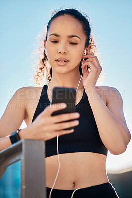 Buy stock photo Outdoor, woman and  smartphone with earphones for fitness on break with exercise, running and workout in Atlanta. Female person, music and playlist, audio and podcast for health and wellness