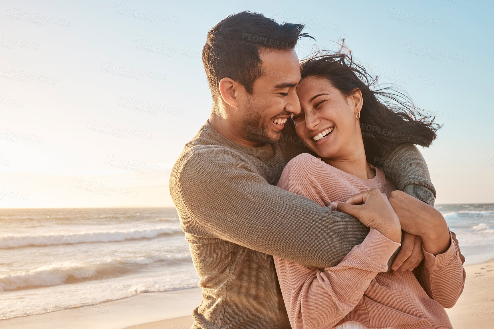 Buy stock photo Travel, sunset and couple with hug at beach for affection, relationship or weekend getaway. Love, hispanic man and happy woman with embrace for vacation, anniversary or romantic date in Zanzibar