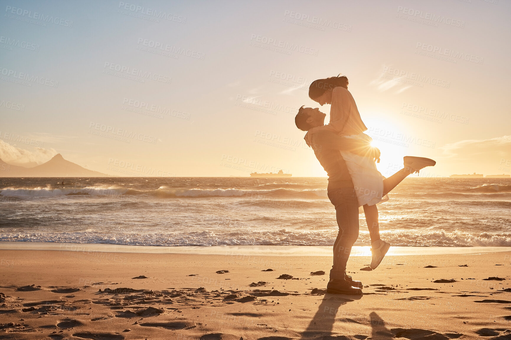 Buy stock photo Love, lifting and couple with sunset at beach for support, relationship or weekend getaway. Travel, ocean and happy man hug woman with affection for vacation, anniversary or romantic date in Zanzibar