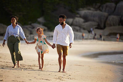 Buy stock photo Shot of a young couple bonding with their daughter at the beach