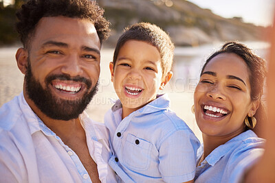 Buy stock photo Shot of a young couple bonding with their son at the beach