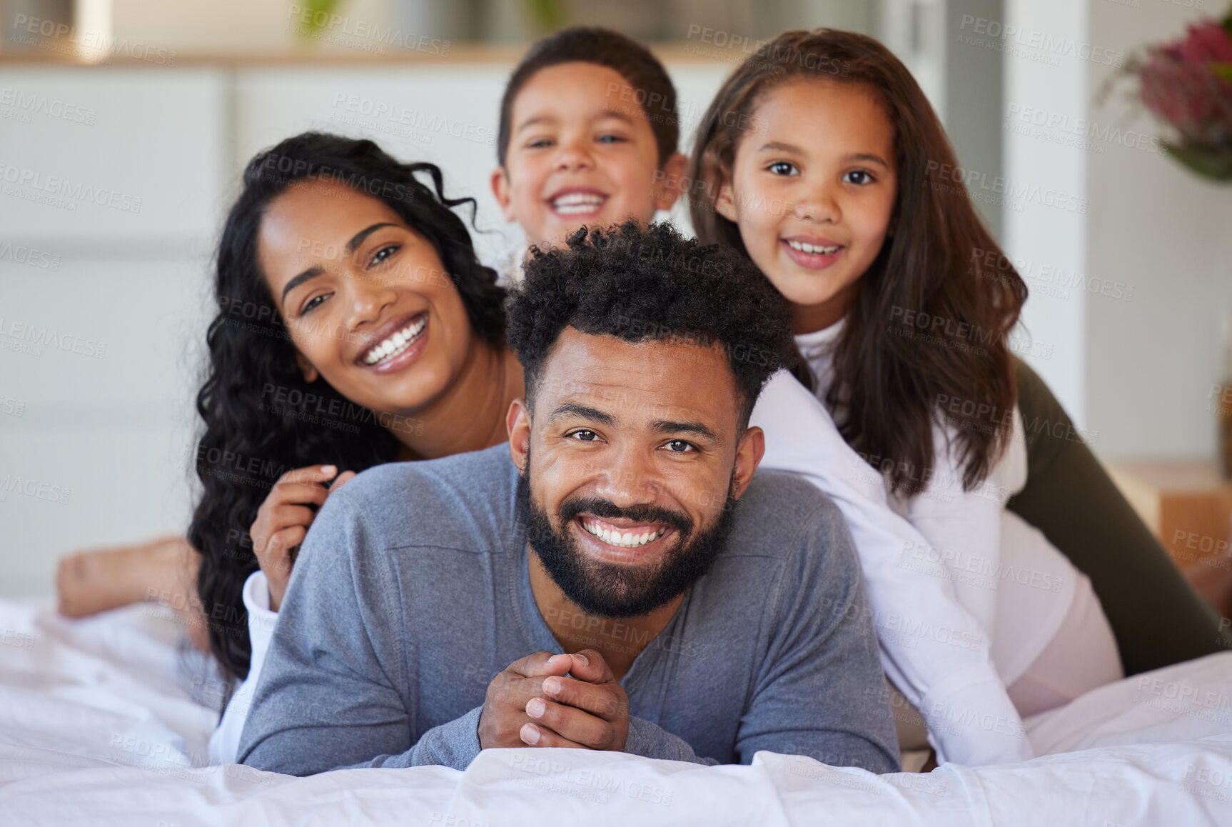 Buy stock photo Family pile, children and happy portrait on bed for support, healthy relationship and security or love in home. Smile, parents and kids on mattress for care, bonding time and stack on father back