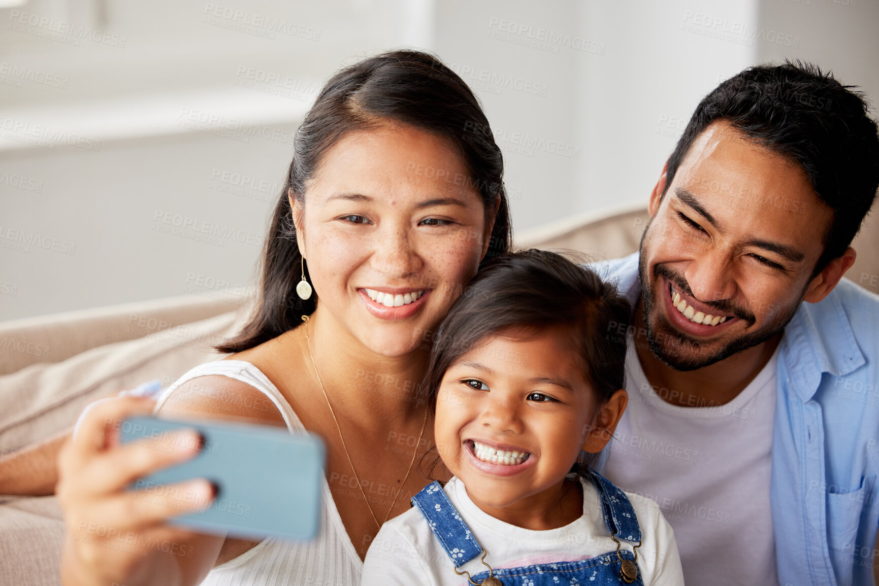 Buy stock photo Selfie, home and mom, dad and girl by sofa for social media, profile picture and online post. Family, love and mother, father and child take photo for bonding, weekend and relax in living room