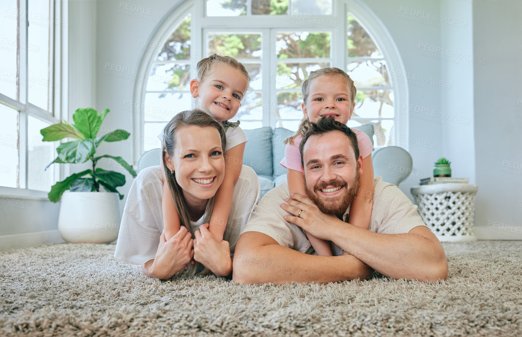 Buy stock photo Shot of a young family relaxing at home