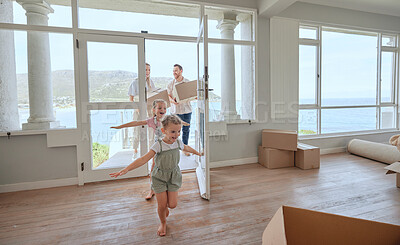 Buy stock photo Shot of a young family moving into their new home