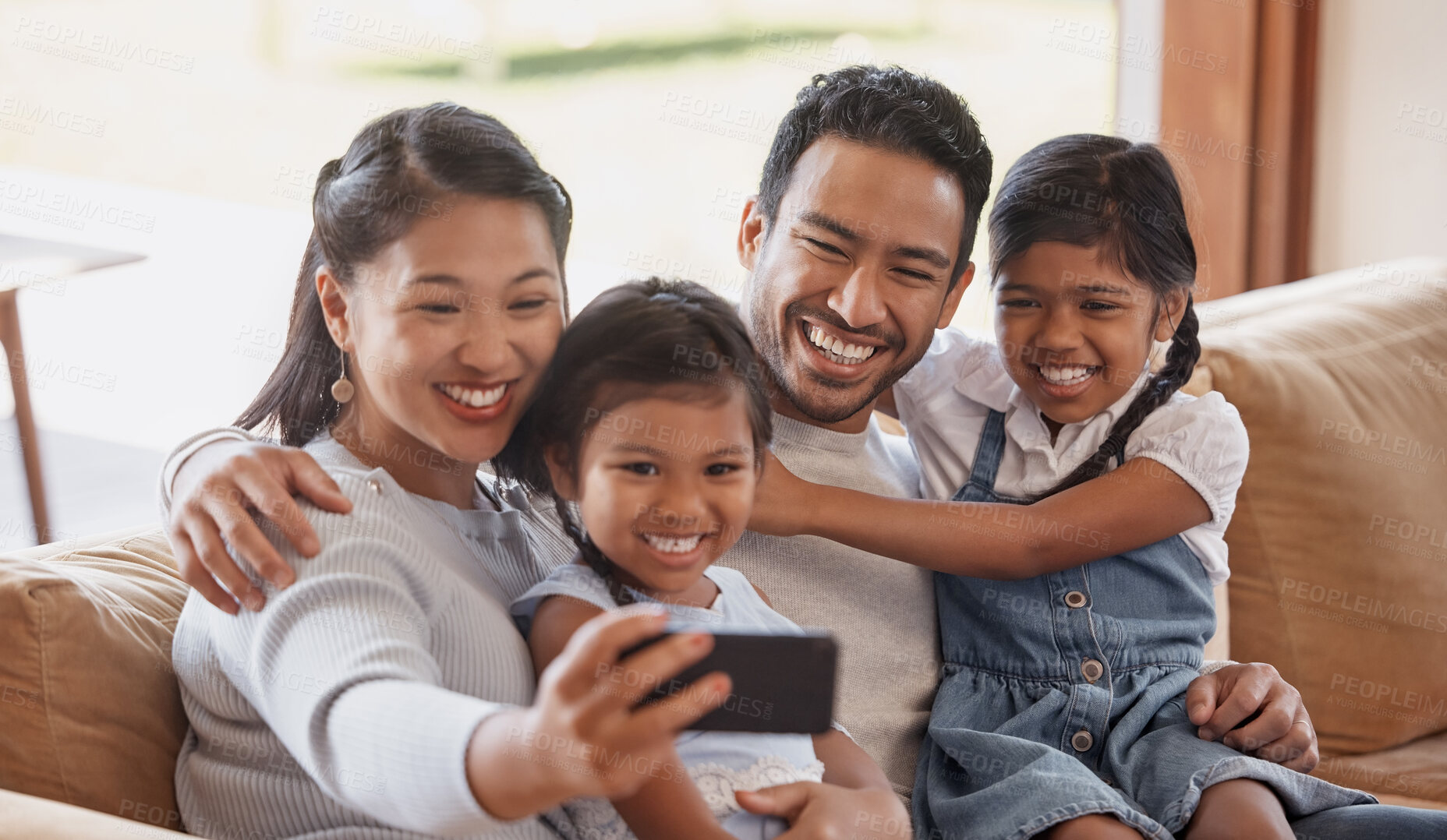 Buy stock photo Asian parents, selfie and happy family with children on sofa for love, connection and kids bonding together. Mom, dad and sisters take picture in home living room for memory, social media and photo