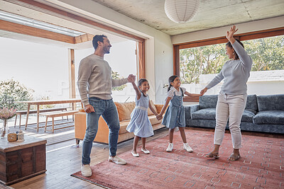 Buy stock photo Full length shot of an affectionate young family of four dancing in the living room at home