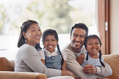 Buy stock photo Cropped portrait of an affectionate young family of four sitting on the sofa at home