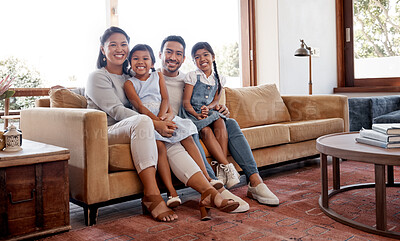 Buy stock photo Full length portrait of an affectionate young family of four sitting in the living room at home