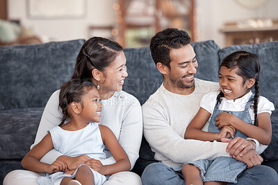 Buy stock photo Cropped shot of an affectionate young family of four sitting on the sofa at home