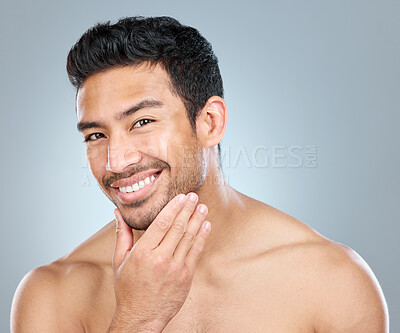 Buy stock photo Portrait, skincare and smile of masculine man in studio on gray background for cosmetic wellness. Beauty, dermatology and natural with face of confident person in bathroom for hydration or hygiene