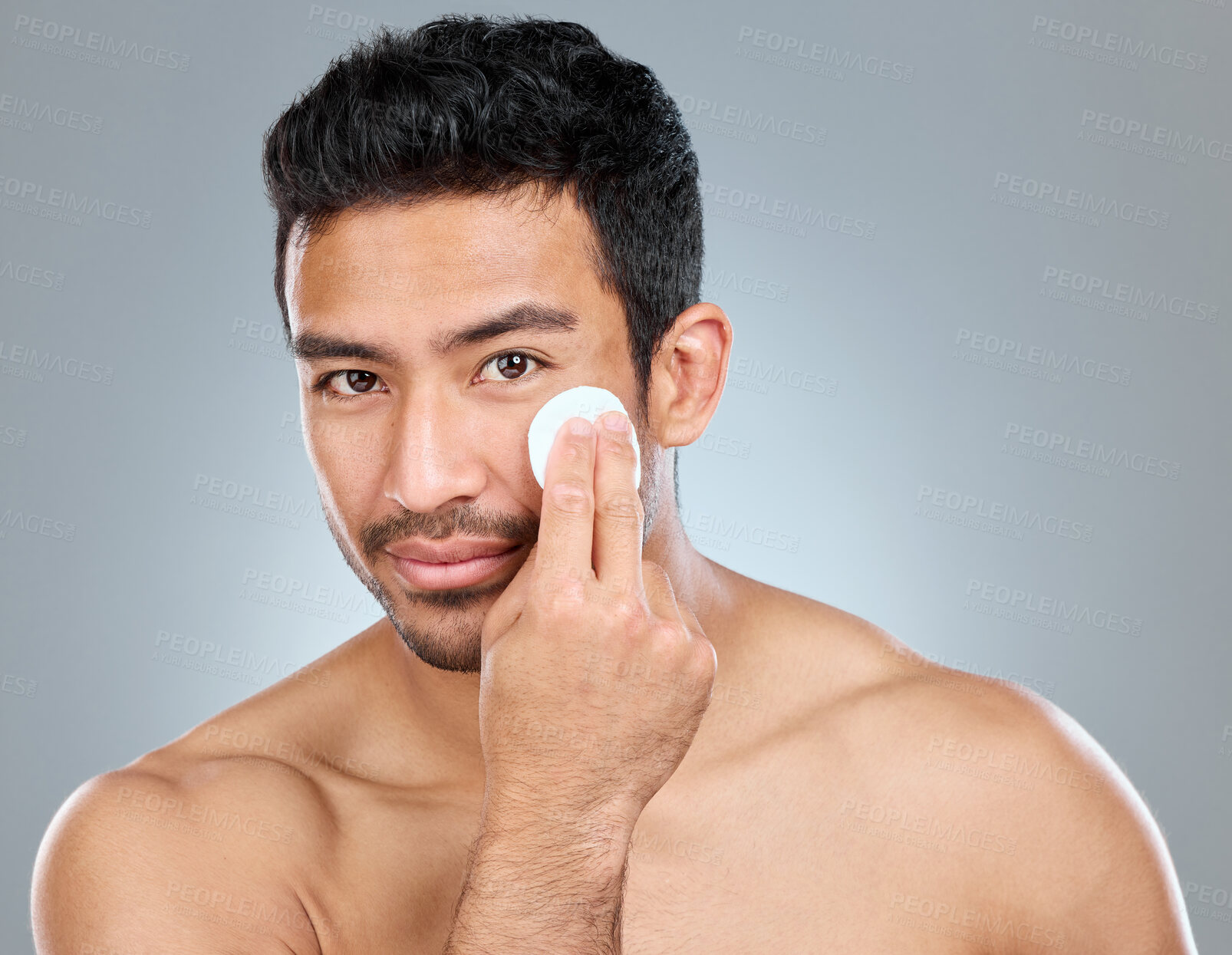 Buy stock photo Beauty, cotton and portrait of masculine man in studio on gray background for cosmetic wellness. Dermatology, cleaning and skincare with face of confident person in bathroom for hydration or hygiene