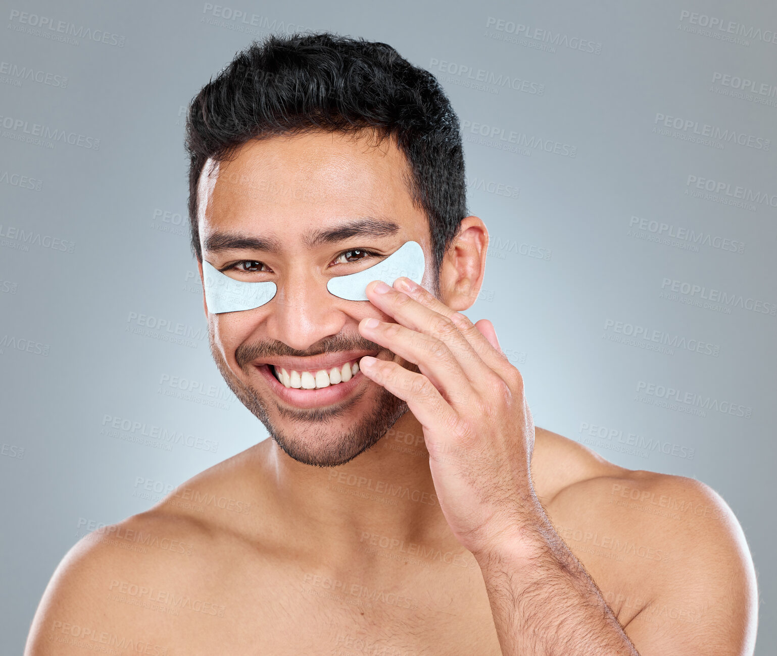 Buy stock photo Beauty, eye mask and portrait of masculine man in studio on gray background for cosmetic wellness. Antiaging, dermatology and skincare with face of happy person in bathroom for hydration or hygiene