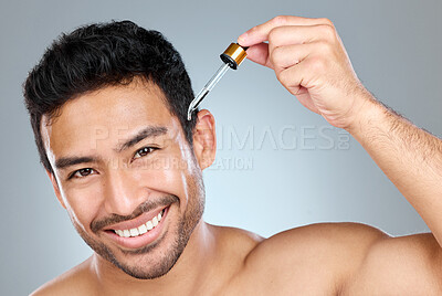 Buy stock photo Skincare, portrait of man or serum in studio for treatment, avocado oil or anti aging product. Male person, pipette or smile for skin routine with vitamin c, liquid or dermatology on gray background