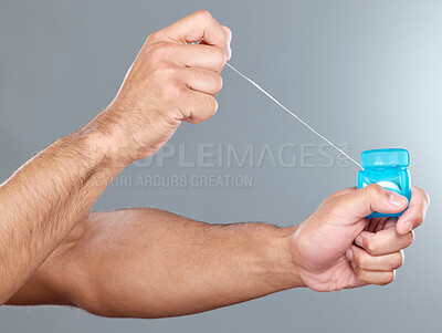 Buy stock photo Hands, floss and dental care for man with product, string and dentist on white background. Healthcare, grooming and hygiene for male person, studio and oral health and container for teeth wellness