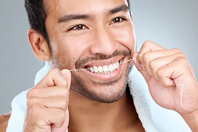 Buy stock photo Asian man, dental and floss in studio for teeth, cleaning and wellness with hands or towel on white background. Model tooth and hygiene for gum health, mouth and breath with oral healthcare.