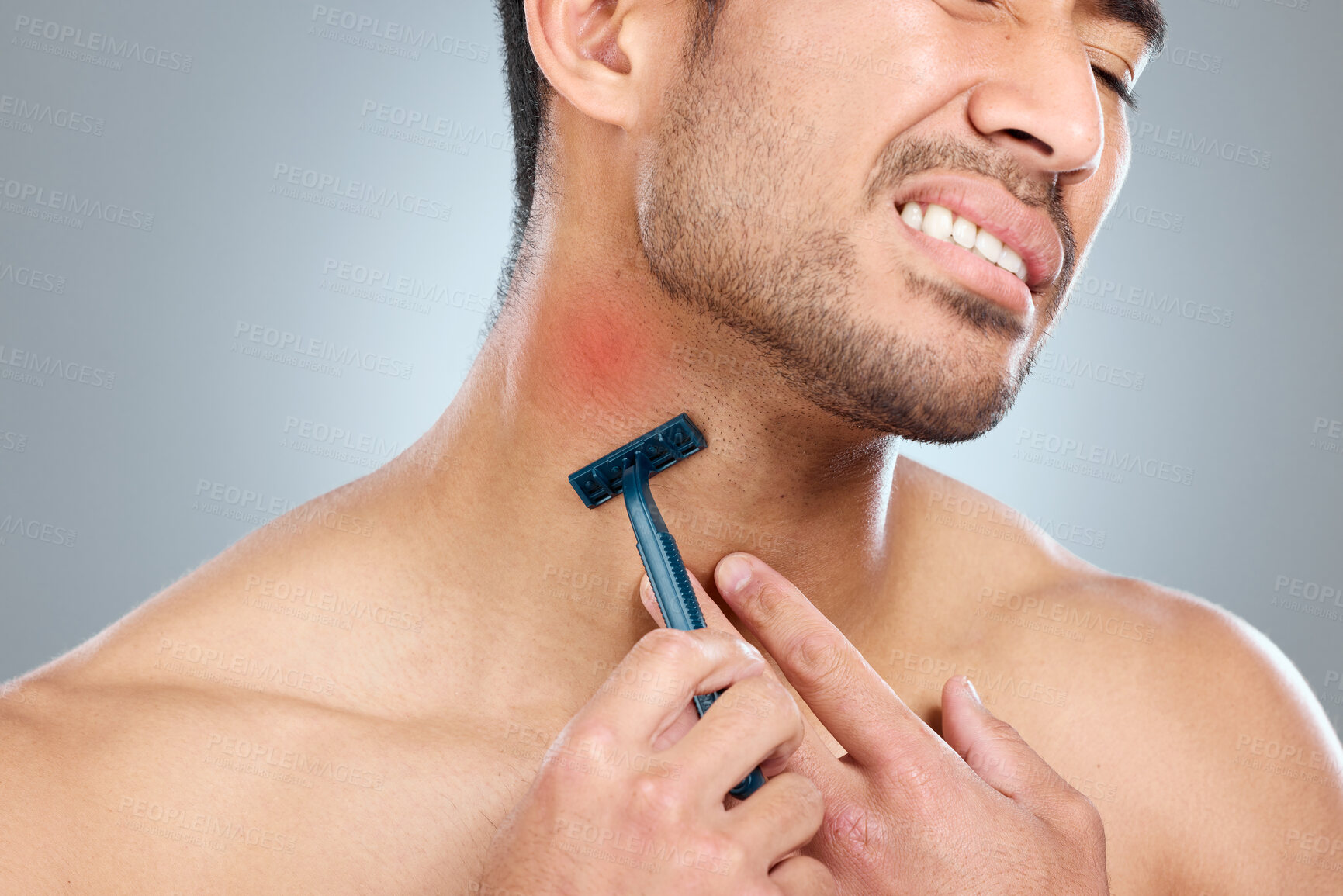 Buy stock photo Man, face and neck shaving injury with self care grooming, healthcare or beard mistake. Pain, model and hair removal accident with cleaning, facial treatment and razor on gray studio background