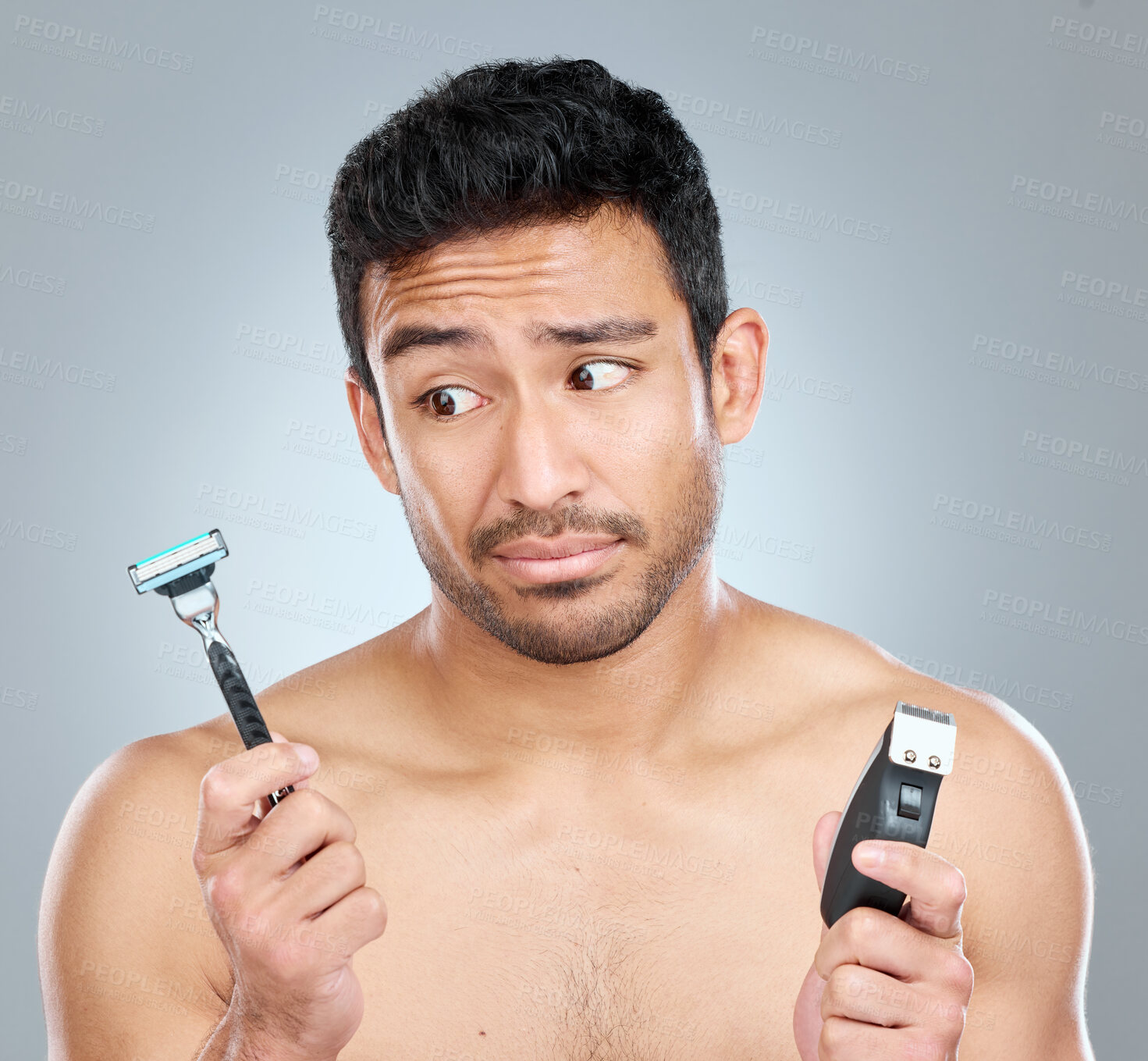 Buy stock photo Man, razor and choice for skincare, grooming or facial treatment on a gray studio background. Hygiene, decision and product for thinking, trimming and confused for morning beard routine with doubt