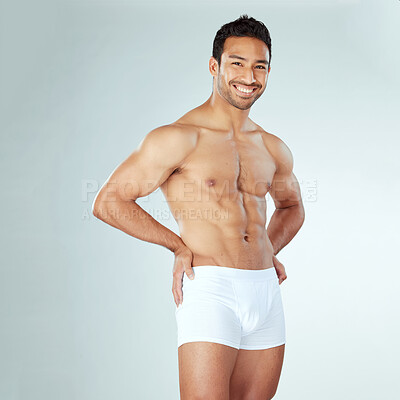 Buy stock photo Shot of a muscular young man posing against a studio background