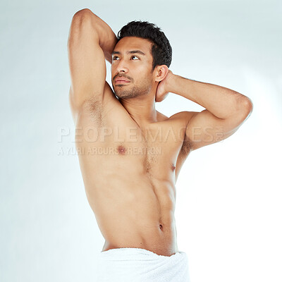 Buy stock photo Stretching, towel and body of asian man looking serious in studio for wellness, shower or cosmetic care on white background. Bathroom, cleaning and male model with glowing skin, results or satisfaction