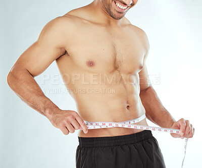 Buy stock photo Measuring tape, stomach and fitness man in studio with weight loss, progress or bmi control on white background. Body, wellness and male model with waist measurement for diet, detox or sixpack check