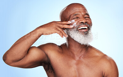 Buy stock photo Cropped shot of a handsome mature man posing in studio against a blue background