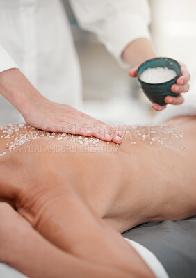 Buy stock photo Shot of a woman having a salt scrub rubbed into her back by a masseuse