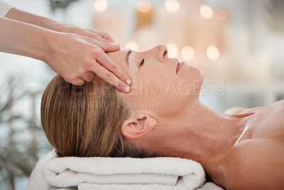 Buy stock photo Shot of a woman receiving a temple massage at a spa