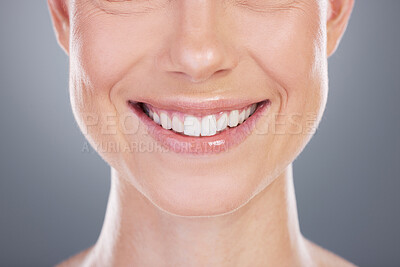 Buy stock photo Studio shot of an unrecognisable woman smiling against a grey background