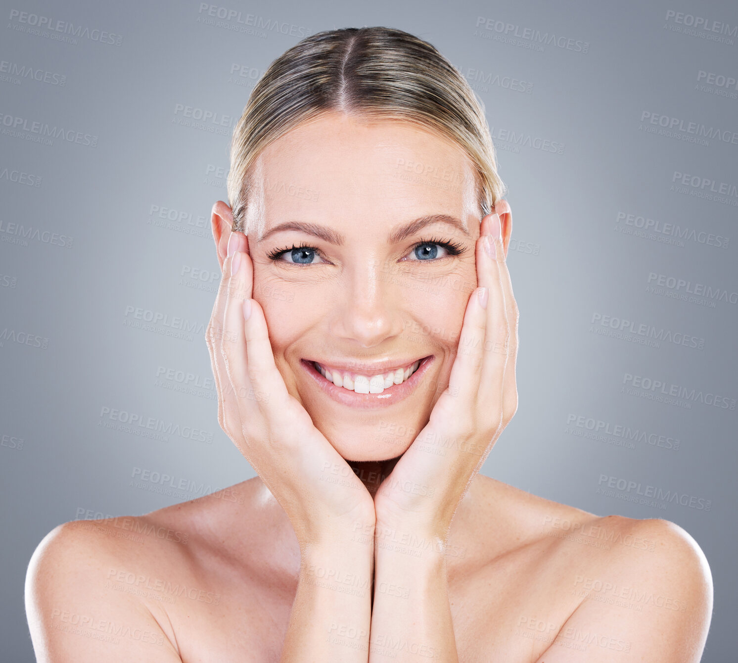 Buy stock photo Female person, face and touch in studio for skincare, beauty and luxury spa treatment on gray background. Woman, happy and confidence for healthy skin, self care and wellness with transformation