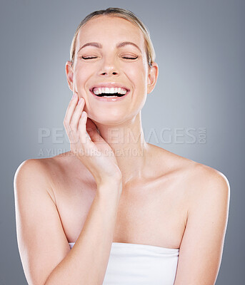 Buy stock photo Studio shot of an attractive mature woman touching her face against a grey background