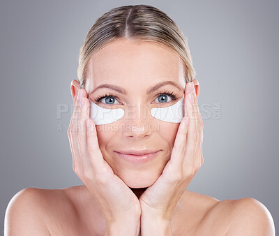 Buy stock photo Happy woman, portrait and eye patches with cosmetics in skincare or anti aging treatment on a gray studio background. Face of female person or model with hydrogel for facial antioxidants or vitamin C